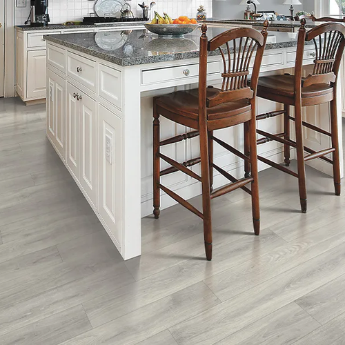 Bright kitchen with neutral Laminate floors